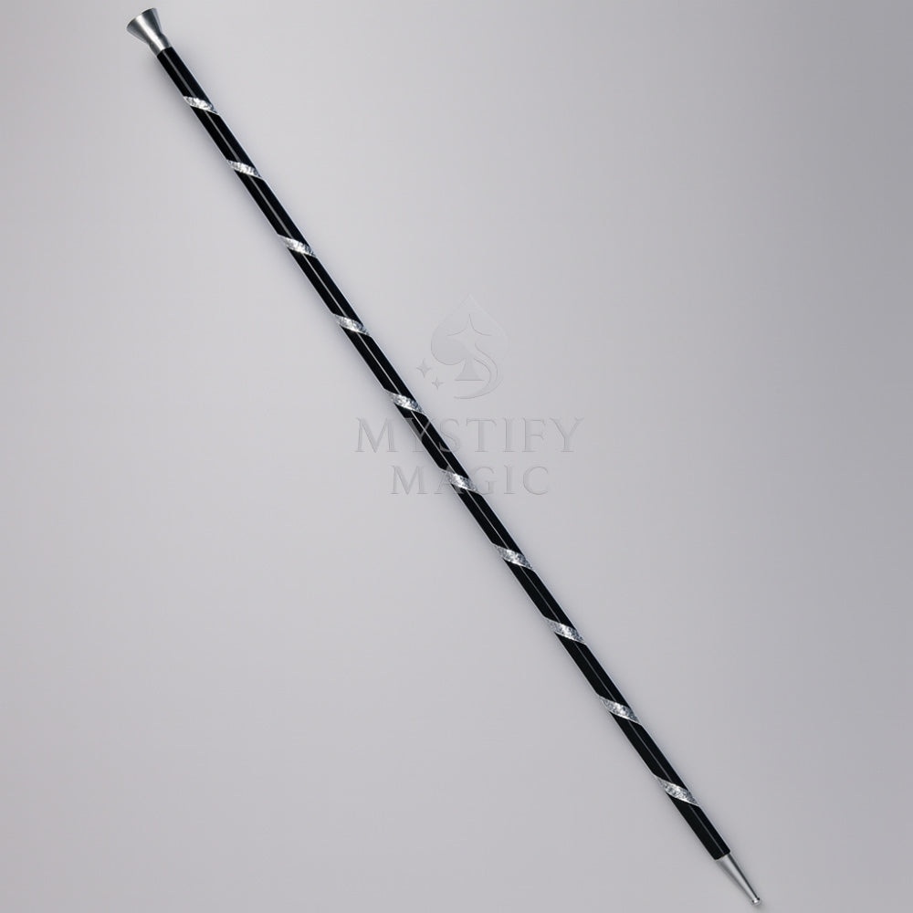 Magician performing the floating aluminum dancing cane magic trick on stage.