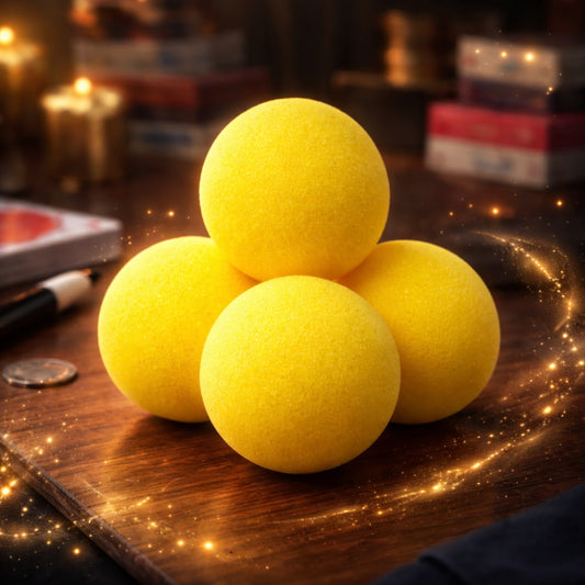 Set of four 4.5 cm super soft yellow sponge balls for magic tricks.