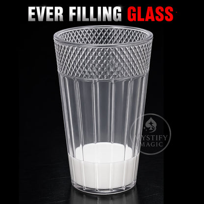 Transparent magic glass full of milk for the Ever Filling Glass trick.