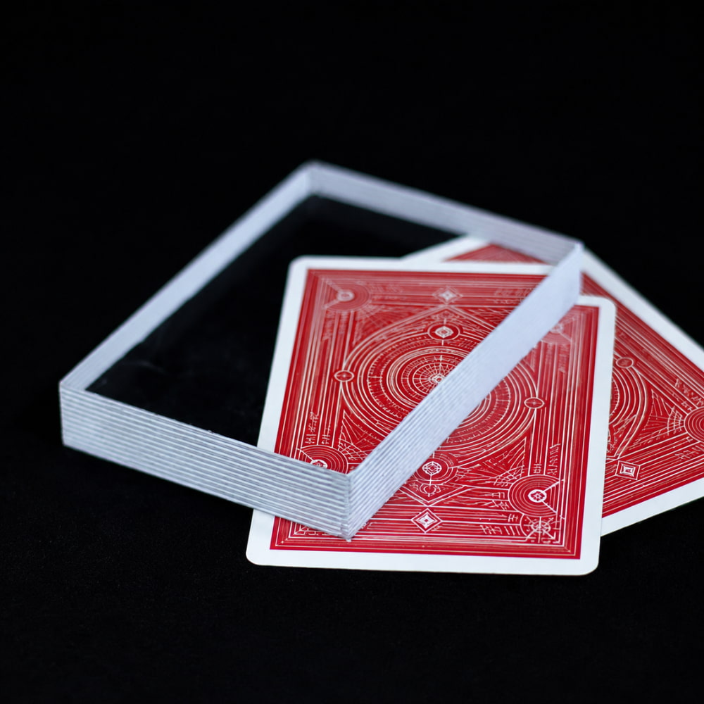Close-up magic prop showing a transparent plastic card block in a spectator's hand.